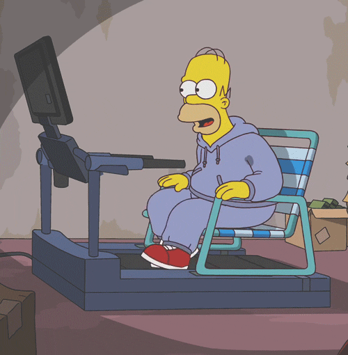 Homer on a treadmill on a chair looking at a computer